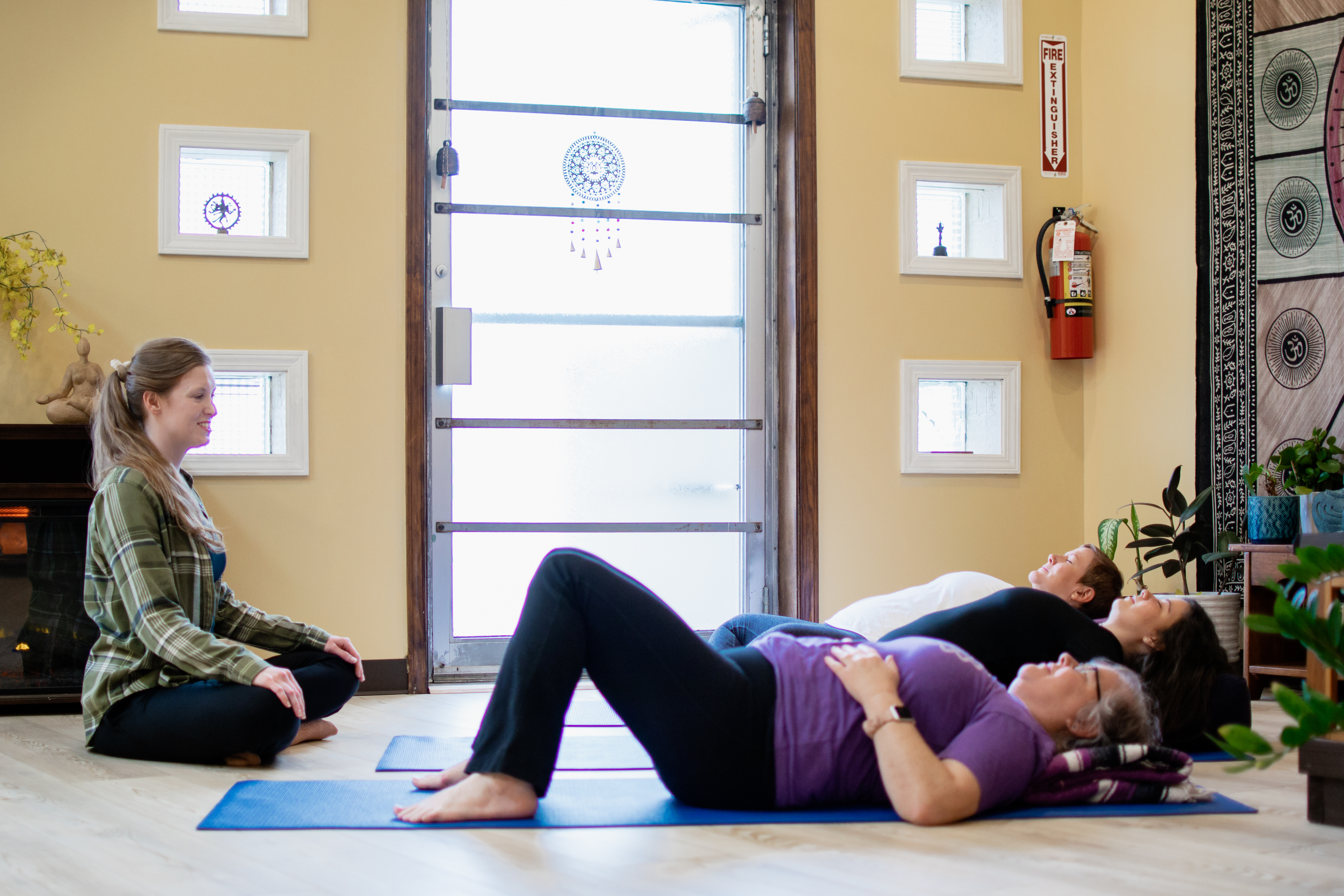 Rachel Red leads a small class through savasana